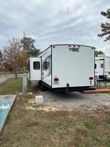 a white trailer is parked in a parking lot at Feel the Vibe in Pensacola
