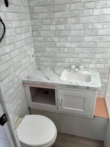 a white bathroom with a sink and a toilet at Feel the Vibe in Pensacola