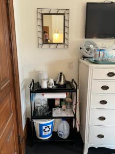 a person taking a picture of a shelf in a room at iKlektik House / Bagley in Detroit