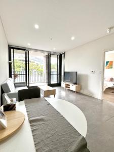 a living room with a couch and a tv at Sydney Olympic Park Walk to Aquatic Centre and Stadium in Sydney