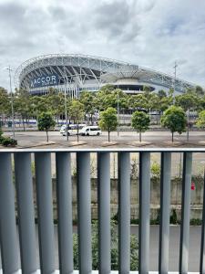 a view of the fnb stadium from a balcony at Sydney Olympic Park Walk to Aquatic Centre and Stadium in Sydney