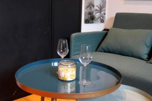 two wine glasses and a jar on a table at Sunny - Studio confortable près de la Tour Eiffel in Paris