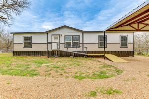 a house with a ramp in front of it at Country Creekside Haven with Private Hot Tub and Deck! in Weatherford