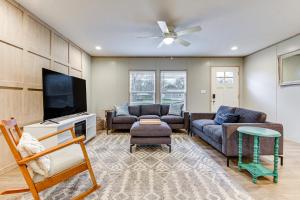a living room with couches and a flat screen tv at Country Creekside Haven with Private Hot Tub and Deck! in Weatherford
