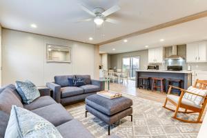 a living room with a couch and a table at Country Creekside Haven with Private Hot Tub and Deck! in Weatherford