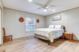 a bedroom with a bed and a ceiling fan at Country Creekside Haven with Private Hot Tub and Deck! in Weatherford