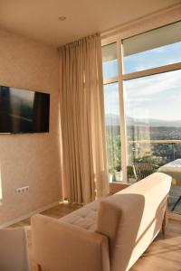 um quarto com uma cama e uma janela grande em Домик 1 Kok Tobe Village em Almaty