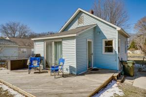 uma casa azul com duas cadeiras num deque em Charming Muskegon Cottage - Walk to Lake Michigan! em Muskegon