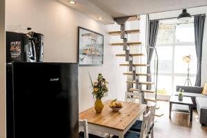 a kitchen and living room with a wooden table and a spiral staircase at Industrial Loft in Berlin Mitte in Berlin