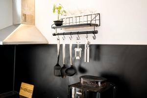 a kitchen with utensils hanging from a wall at Industrial Loft in Berlin Mitte in Berlin