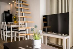 a living room with a table with a tv and a table sidx sidx at Industrial Loft in Berlin Mitte in Berlin