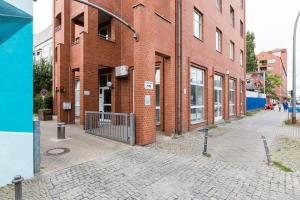 a red brick building with a gate in front of it at Industrial Loft in Berlin Mitte in Berlin