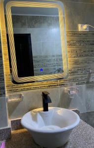 a white sink in a bathroom with a mirror at Fantasy in Port Ghalib