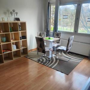 a room with a table and chairs and a window at MO HOME24 in Cologne