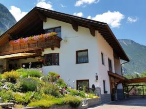a house with a balcony with flowers on it at Holiday apartment Haus Frank in Nassereith