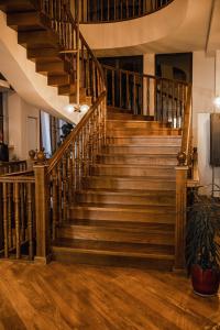 a staircase in a house with wooden floors at Makmani Hotel in Tbilisi City