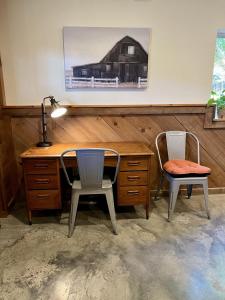an office with a desk and two chairs and a lamp at Comfortable home near wineries and hiking farmhouse in Hendersonville
