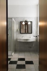 a bathroom with a sink and a mirror at Hotel Villa Policreti in Castello dʼAviano