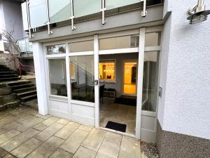 an entrance to a building with sliding glass doors at Ferienwohnung zur Birke in Neuhausen ob Eck