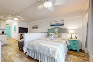 a bedroom with a bed and a blue dresser at Daytona Beach Club Unit 523 in Daytona Beach