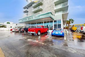 a parking lot with cars parked in front of a building at Daytona Beach Club Unit 523 in Daytona Beach