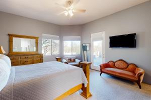 a bedroom with a bed and a flat screen tv at The Fox Den in Tucson