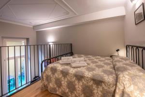 a bedroom with a bed with two towels on it at 227 - Largo Zecca Luxury Apartment - Nel cuore del centro di Genova in Genova
