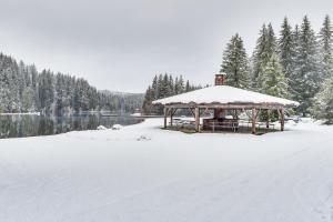 a gazebo covered in snow next to a lake at Awesome Hoodsport Cabin - Nearby Hiking Areas in Hoodsport