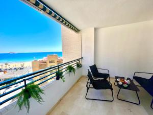 a balcony with chairs and a view of the beach at Paradise Home By Gloove in Villajoyosa