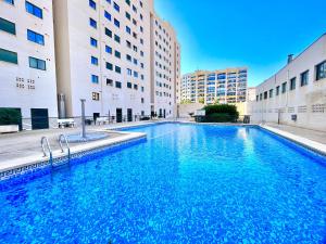 a large swimming pool in front of some buildings at Paradise Home By Gloove in Villajoyosa