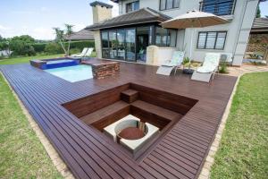 a deck with a fire pit in the middle of a yard at Luxury Countryside Gataway Hillcrest in Hillcrest