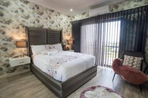a bedroom with a large bed and a window at Luxury Countryside Gataway Hillcrest in Hillcrest