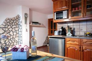 a kitchen with a table with a bottle of wine at Zoltán Borháza in Tihany