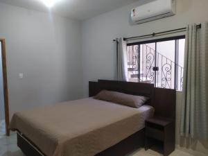 una camera da letto con un letto e una finestra con balcone di Novo Horizontes a São João del Rei Altre 7 foto