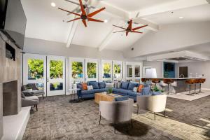 a large living room with blue couches and chairs at Oceanside Beach style King & 2 queen beds in Oceanside