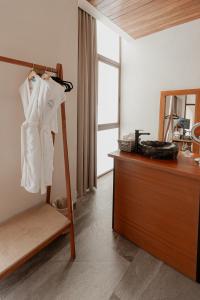 a room with a dresser with a robe on it at Prana Boutique Hotel Tulum in Tulum