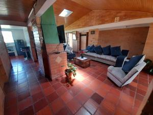 una gran sala de estar con sofás y TV. en Villa pinzon en Paipa
