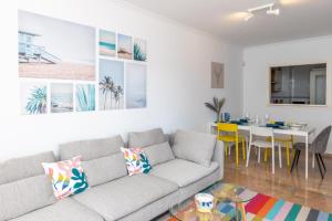 a living room with a couch and a dining room at Cozy beachfront 2BR with Terrace, Pool and Garage in Sitio de Calahonda