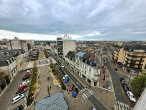 a city with cars parked in a parking lot at La Case à Jeannette in Châteauroux