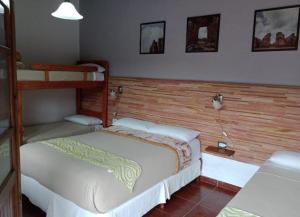 um quarto com 2 beliches num quarto em Hostería Montes em San Ignacio