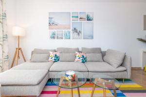 a living room with a couch and a glass table at Cozy beachfront 2BR with Terrace, Pool and Garage in Sitio de Calahonda