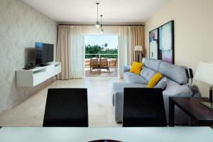 a living room with a couch and a television at Malibu Mansions by the beach by ALFRESCO STAYS in Mijas Costa +263 photos