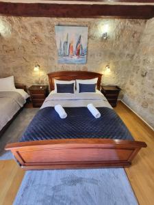 1 dormitorio con 1 cama grande de madera y 2 almohadas en Green Exclusive Apartments en Dubrovnik