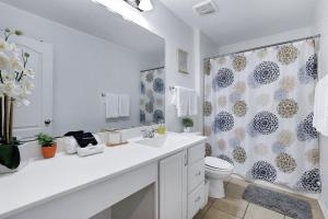 a bathroom with a sink and a toilet and a shower at Tranquility - A Birdy Vacation Rental in San Antonio