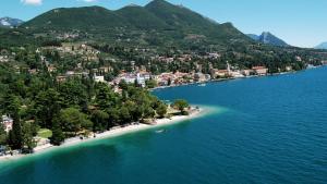 an island in the middle of a large body of water at Happy Hotel Atelier Gardone Riviera Centro & Beach in Gardone Riviera