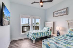 a bedroom with two beds and a window at Fishtastic SP103 in Rockport +46 photos