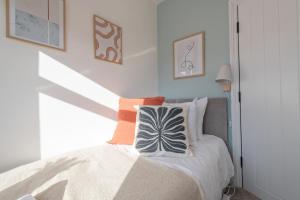 a bedroom with a bed with two pillows on it at Elland Retreat By NordStay in Beeston Hill