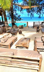 a beach with a table and chairs on the beach at Boho Boutique Villa - Adults Only in Kiwengwa