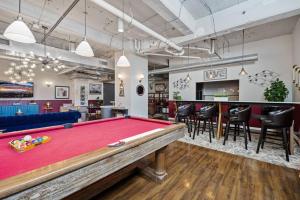 a pool table in a room with a bar at Stunning Downtown Apartment with Pool, Laundry, Parking in Dallas