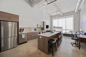 a large kitchen with a large island in a room at Luxurious Downtown Apt / Pool, Laundry, Parking in Dallas